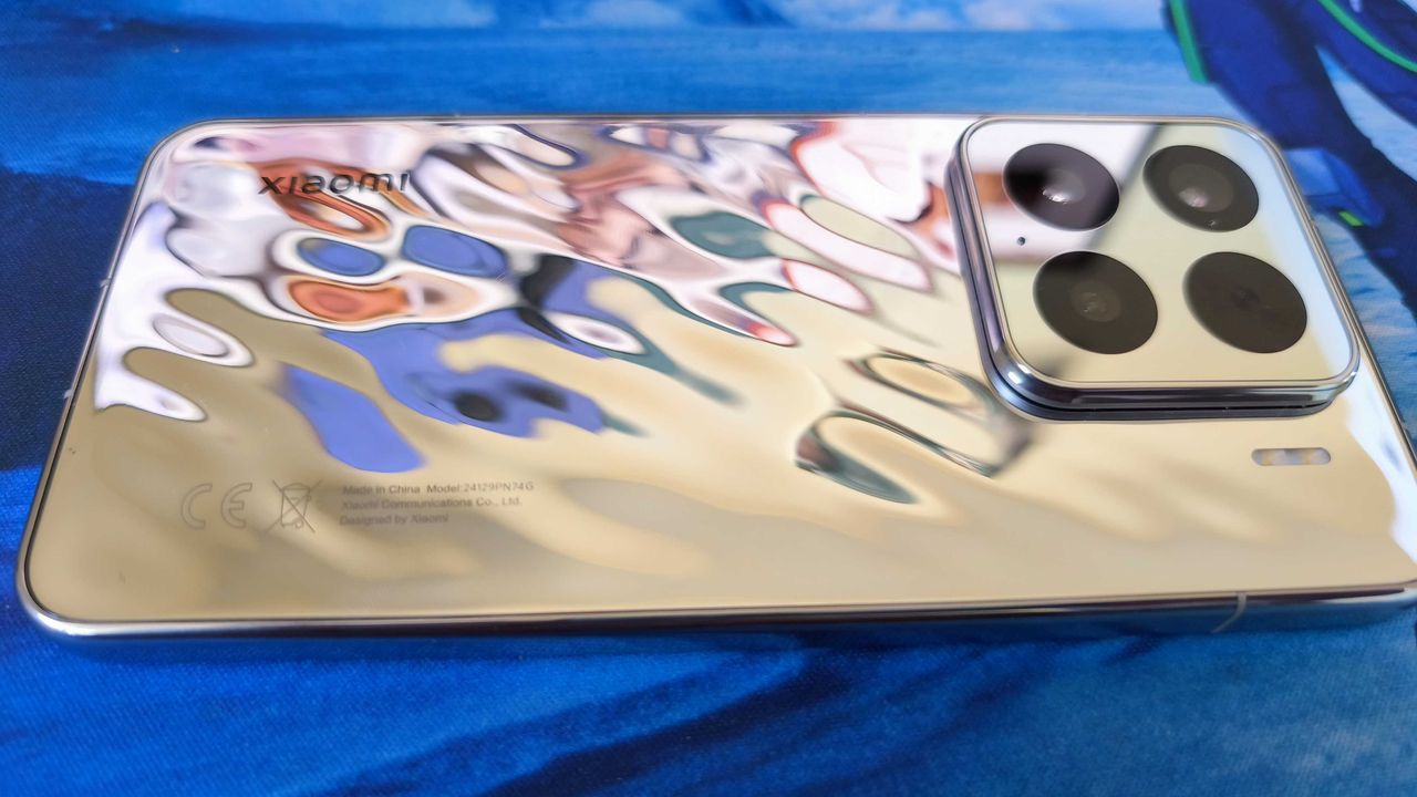 A liquid silver Xiaomi 15 on a detailed blue background