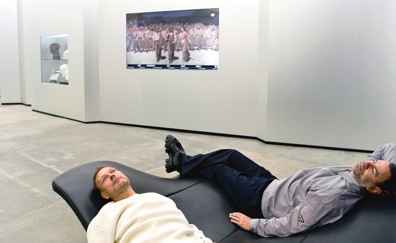 Artists Elmgreen &amp; Dragset at their major solo presentation &#039;Useless Bodies?&#039; at Fondazione Prada, Milan, lounging on an &#039;EJ 142 Waves&#039; sofa by Danish designers Anne-Mette Jensen and Morten Ernst