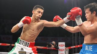 Boxer Rafael Espinoza, wearing shorts in the red, green and white colors of Mexico, throws a punch in the ring ahead of the Ramirez vs Espinoza boxing 
