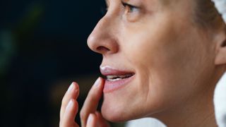 woman applying lip balm