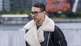 Christian Siriano in a black and white coat in Project Runway All-Stars