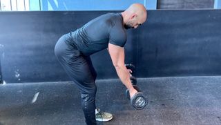 a photo of trainer Ali Malik performing a Bent Over Underhand Dumbell Row