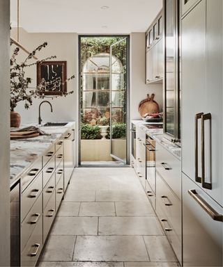 timeless neutral kitchen with stainless steel appliances and marble countertop