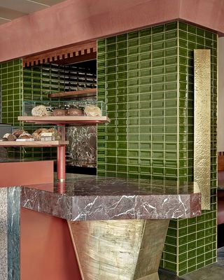 A green tile wall of the restaurant counter