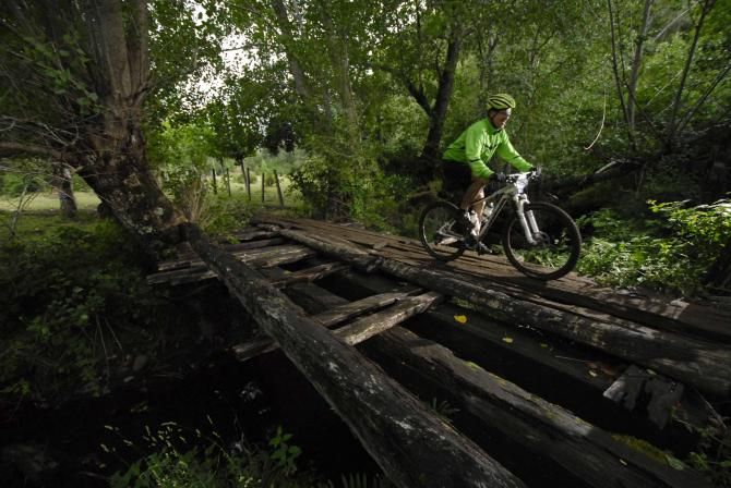 A rider crosses a bridge