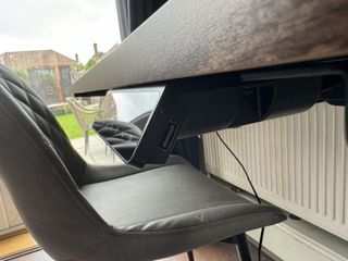 A brown wooden Maidesite TH2 Pro Plus desk in a bright home office