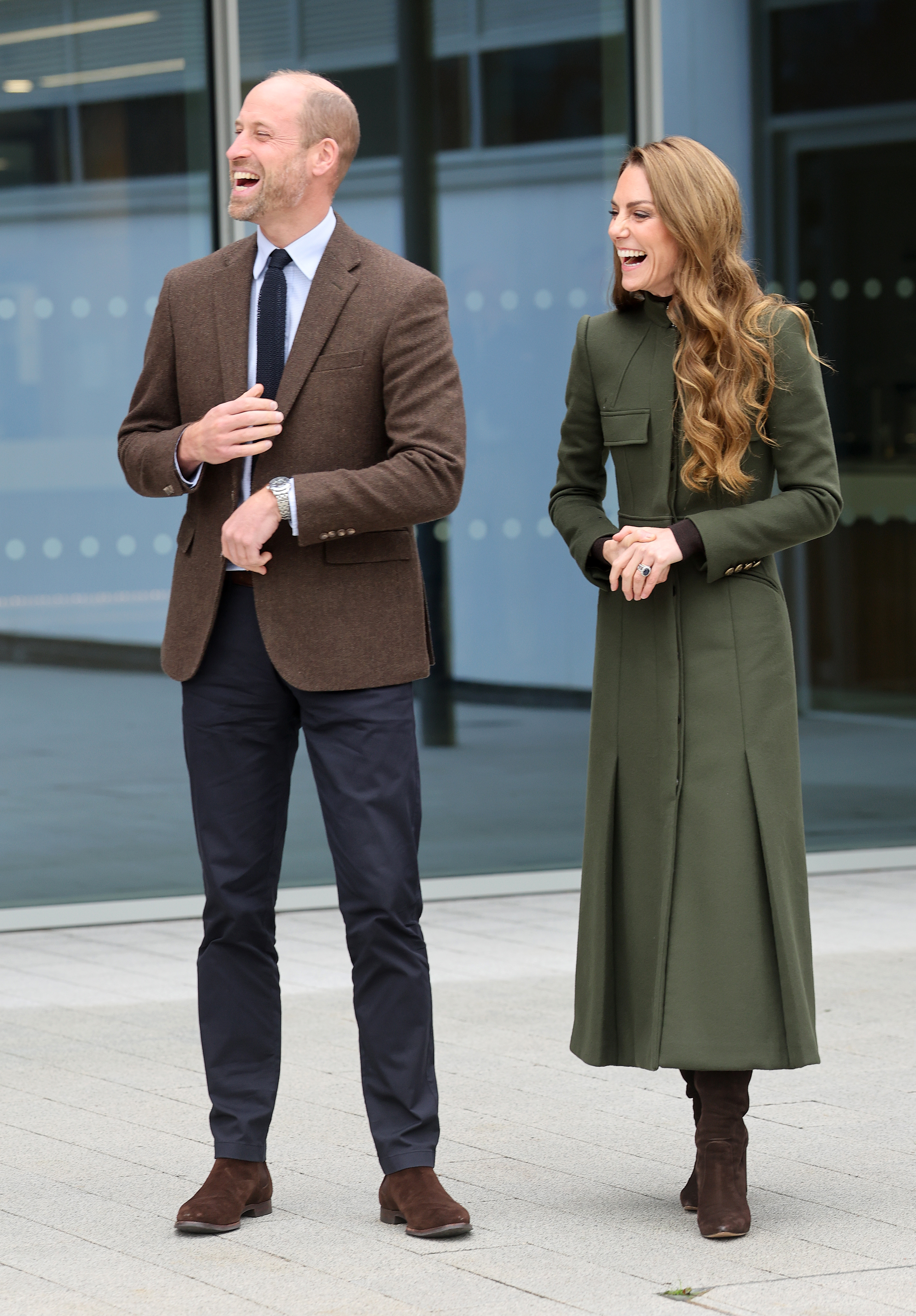 Kate Middleton and Prince William standing next to each other and laughing