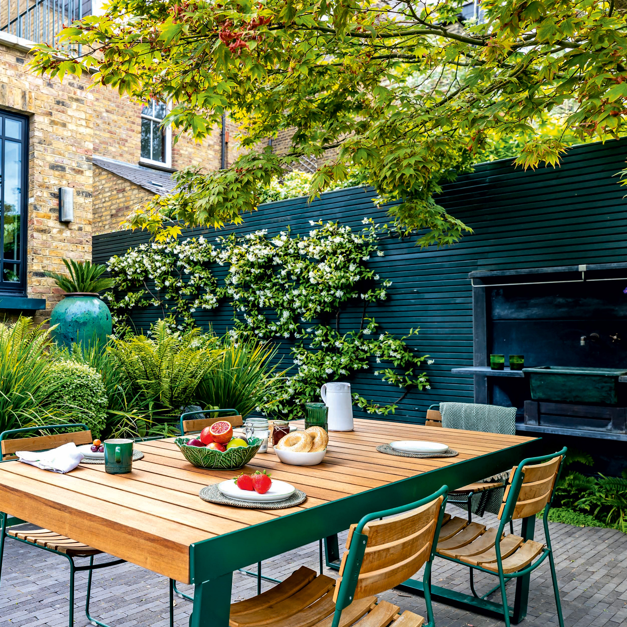 garden makeover with a dining table and chairs, outdoor kitchen and kitchen sink