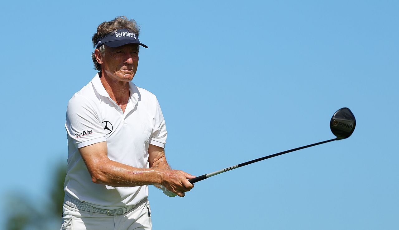 Bernhard Langer watches his tee shot after striking the golf ball