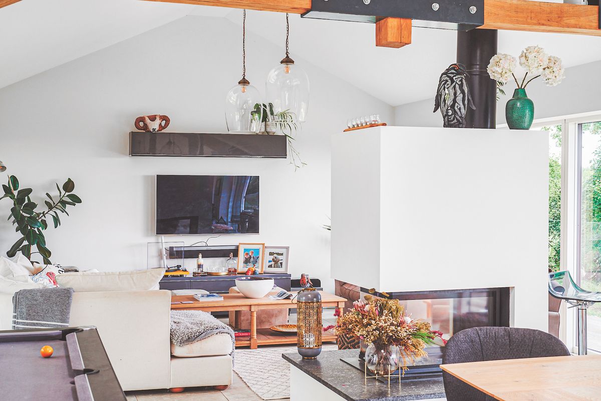 living room in open plan space with double sided gas fireplace