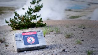 Thermal pool warning sign at Yellowstone National Park, USA