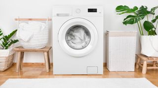 White items inside a washing machine next to laundry baskets