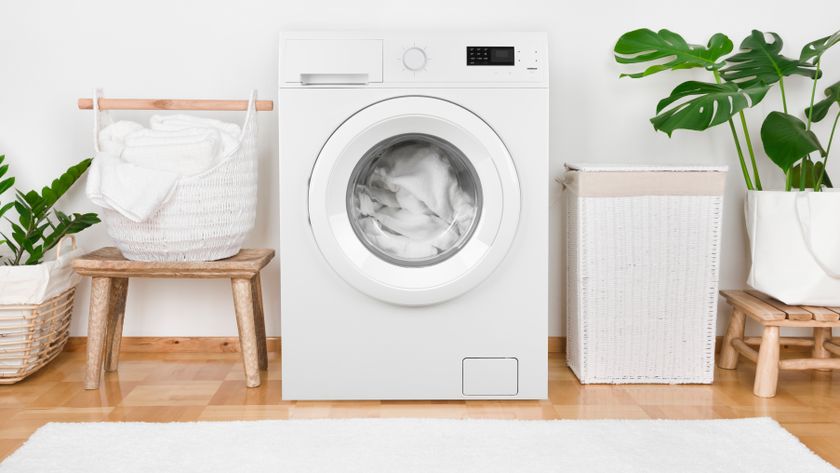White items inside a washing machine next to laundry baskets