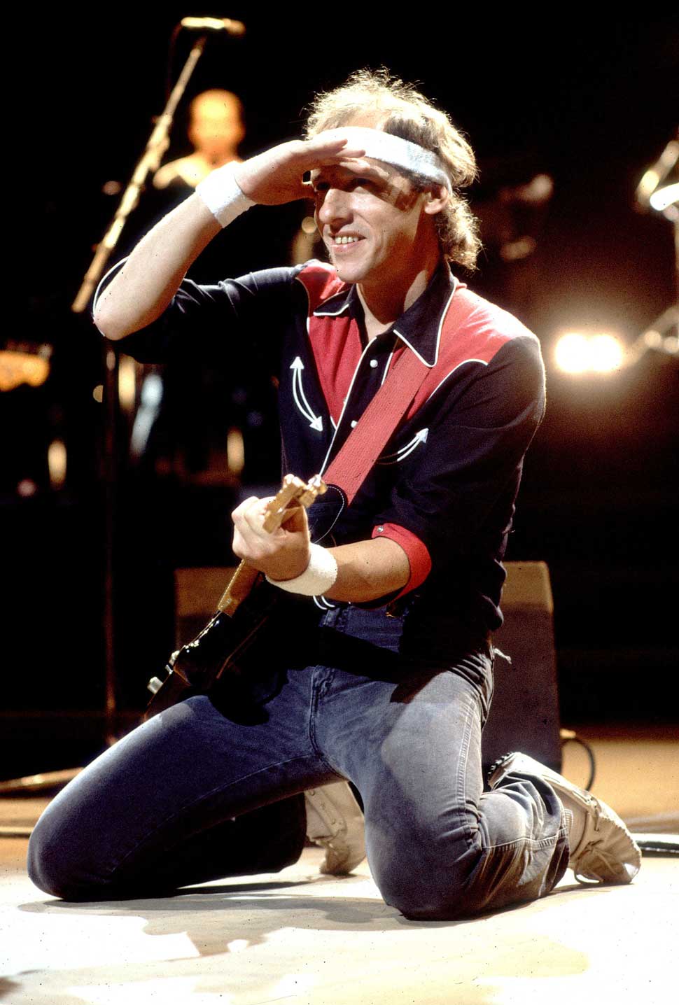 Mark Knopfler on his knees onstage