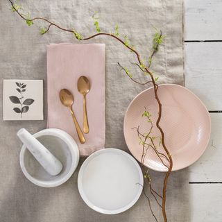white table with copper spoons and dishes