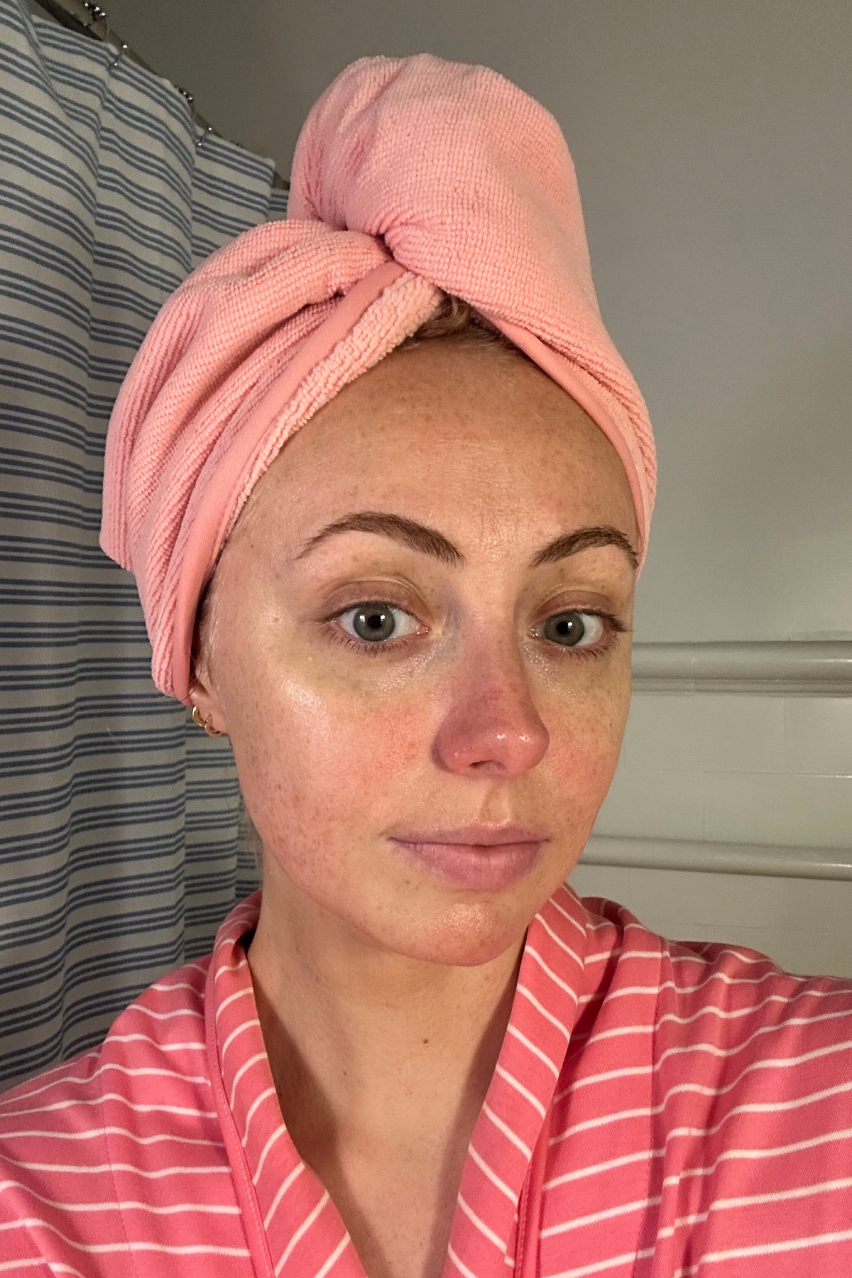 Emery Doney before using the Maybelline Fit Me Matte + Poreless Liquid Foundation with a pink head towel and pink robe