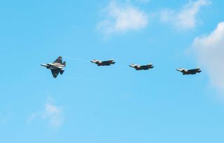 Four F-35C Lightning II joint strike fighters fly in formation over Naval Air Station Lemoore.
