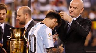 Gianni Infantino presents Lionel Messi with a runners-up medal at the 2016 Copa America Centenario.