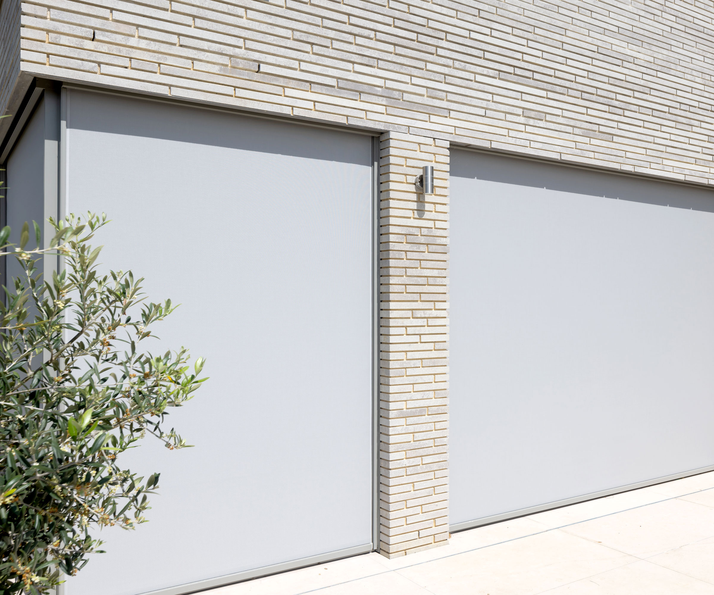 Grey Kensington Blinds external blinds covering large windows on exterior of contemporary home