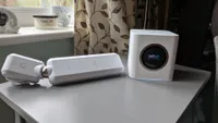The Ubiquiti Amplifi HD on a gray table in front of a window