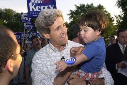 John Kerry, kissing babies in the doldrums of summer 2003