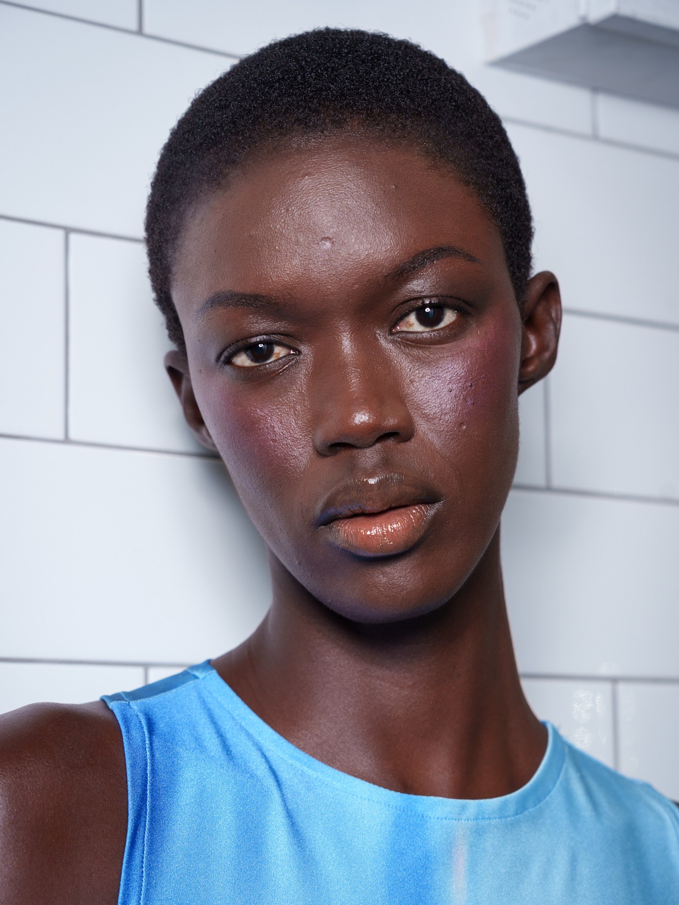 A model wearing a purple-y mulled wine berry blush look&amp;mdash;a perfect NYE makeup idea.