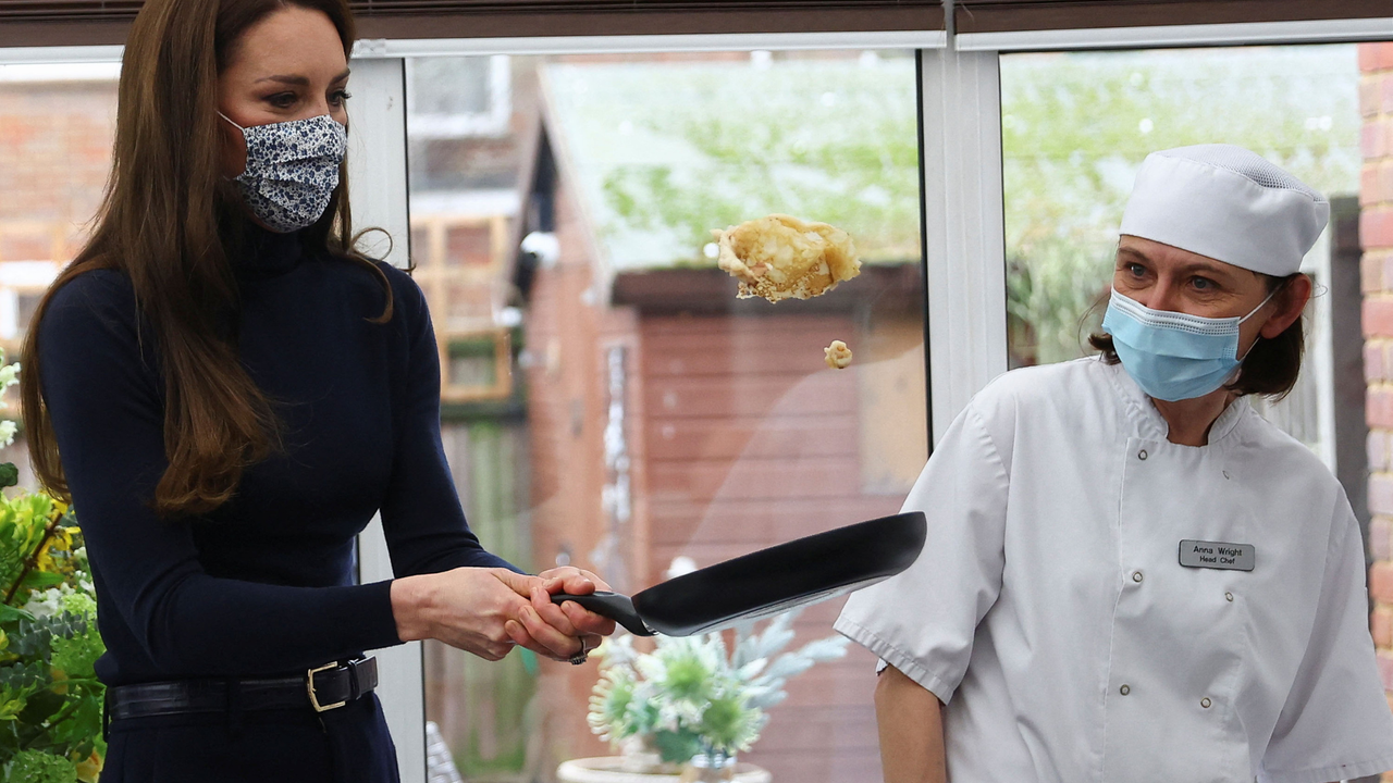 Catherine, Princess of Wales, flips a pancake as she visits the Oxford House Nursing Home to meet with staff and residents and hear how delivering high-quality, patient-focused care is at the centre of the homes work on February 21, 2023 in Slough, England.