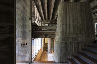 brutalist 1970s house by chu ming silveira showing raw concrete and lived in interiors and green garden