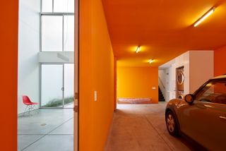 House with orange coloured parking area