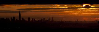 Photographer Nicholas Sperling captured this photo of a partial solar eclipse over the New York City skyline from Eagle Rock Reservation in West Orange, NJ on Nov. 3, 2013 during a rare hybrid solar eclipse.