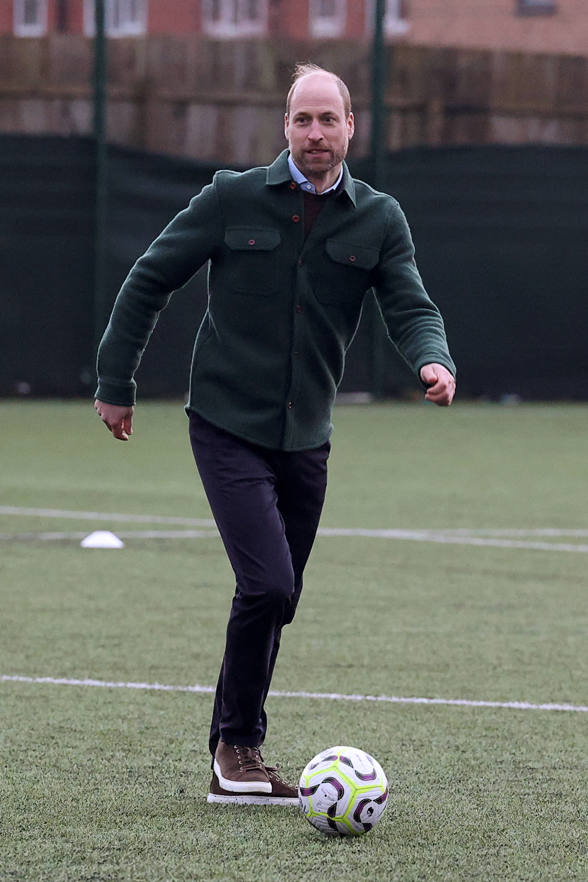 Prince William kicking a soccer ball