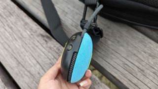 Edifier MP100 Plus attached to a backpack loop