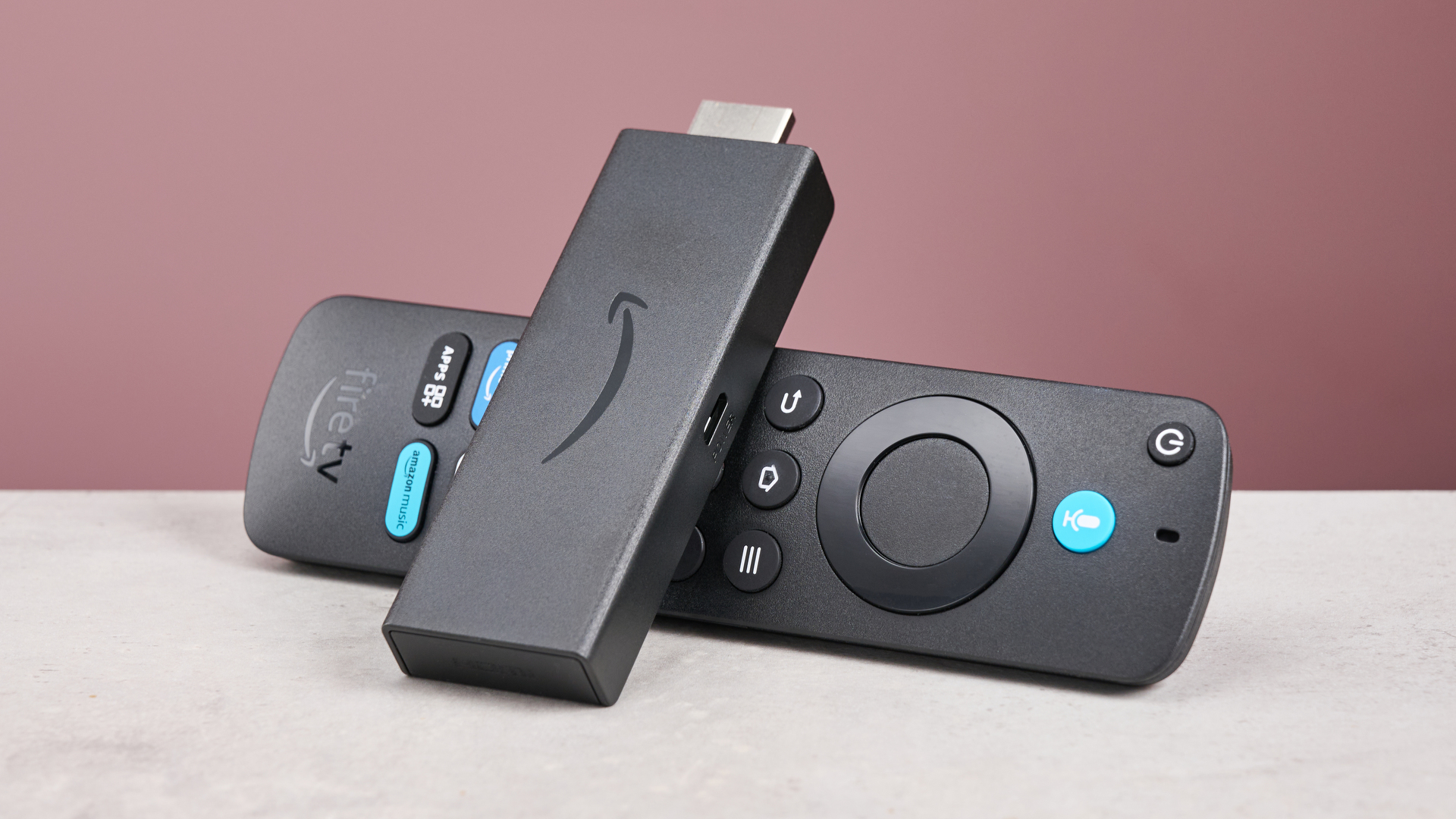 The Amazon Fire TV Stick HD is balanced against its remote control.