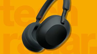 a pair of the best headphones against a yellow TechRadar background
