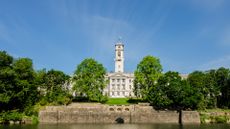 Trent building at Nottingham University with the Highfields Lake in foreground, with clear blue skies above.