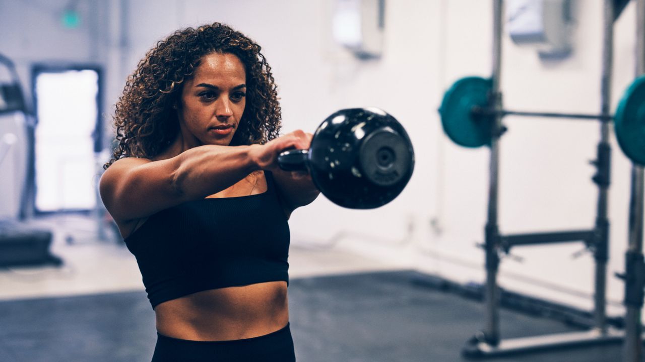 Woman performing kettlebell swings