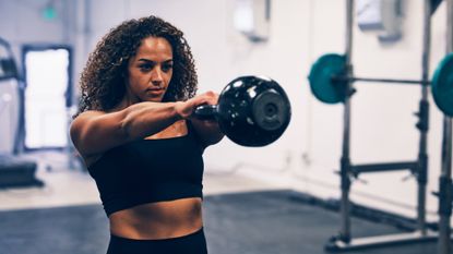 Woman performing kettlebell swings