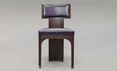 a chair in dark oak with a leather seat and back and bronzed feet