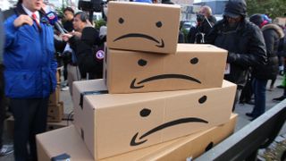 Amazon boxes with the smiling arrow turned upside down and eyes added to create a stack of frowning faces