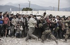 Migrants wait for a train in Macedonia.