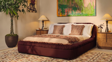A chic bedroom with classic white bed sheets and burl wood bedside table