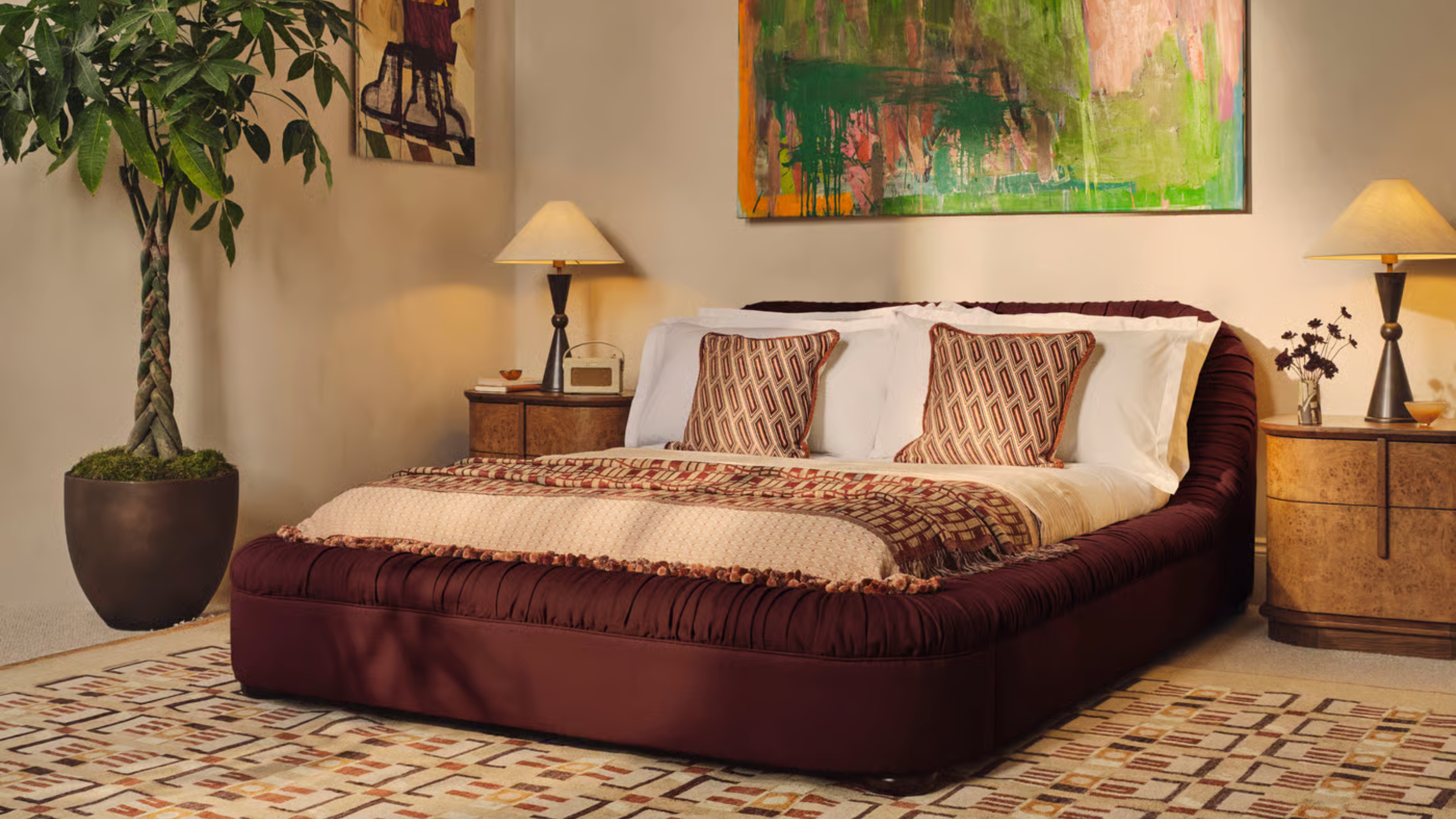A chic bedroom with classic white bed sheets and burl wood bedside table