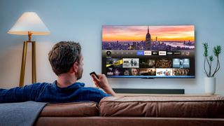 Fire TV on wall with users trying new Alexa Plus feature 