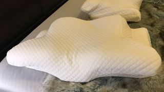 Zamat Butterfly Shaped Cervical Memory Foam Pillow on a bed