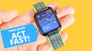 Apple Watch SE shown in a user's hand on a neon green and grey fabric strap; the background is bright orange