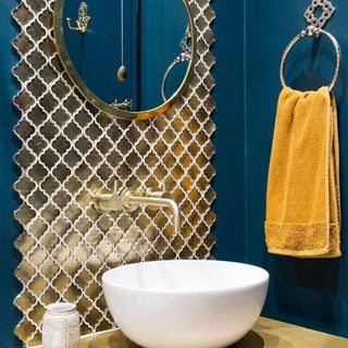 Gold tiles in a bathroom splashback