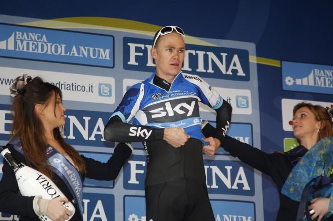 Chris Froome (Team Sky) pulls on the leader's jersey