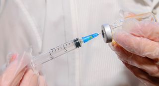 A vaccine syringe and vial.