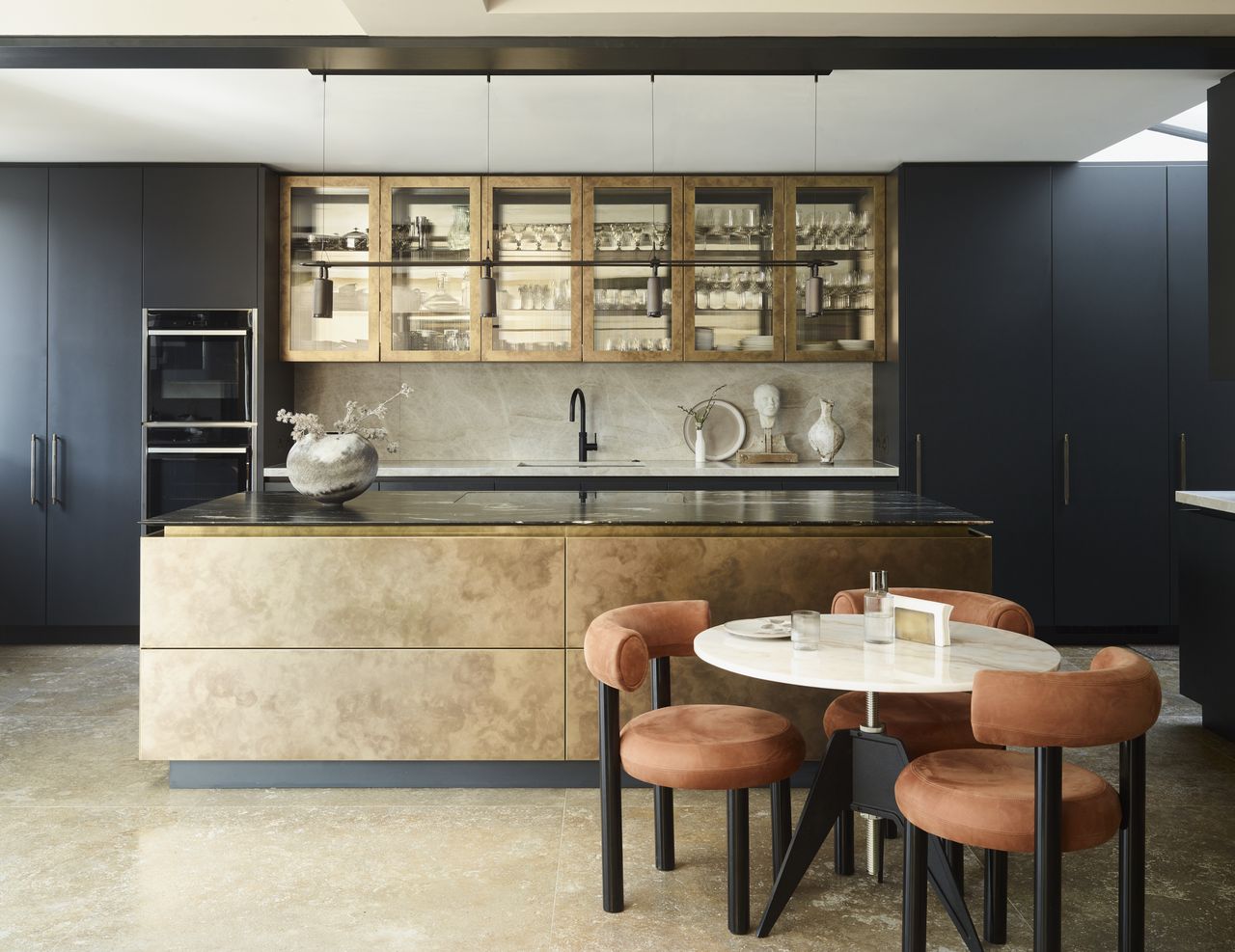 gold kitchen with modern chairs