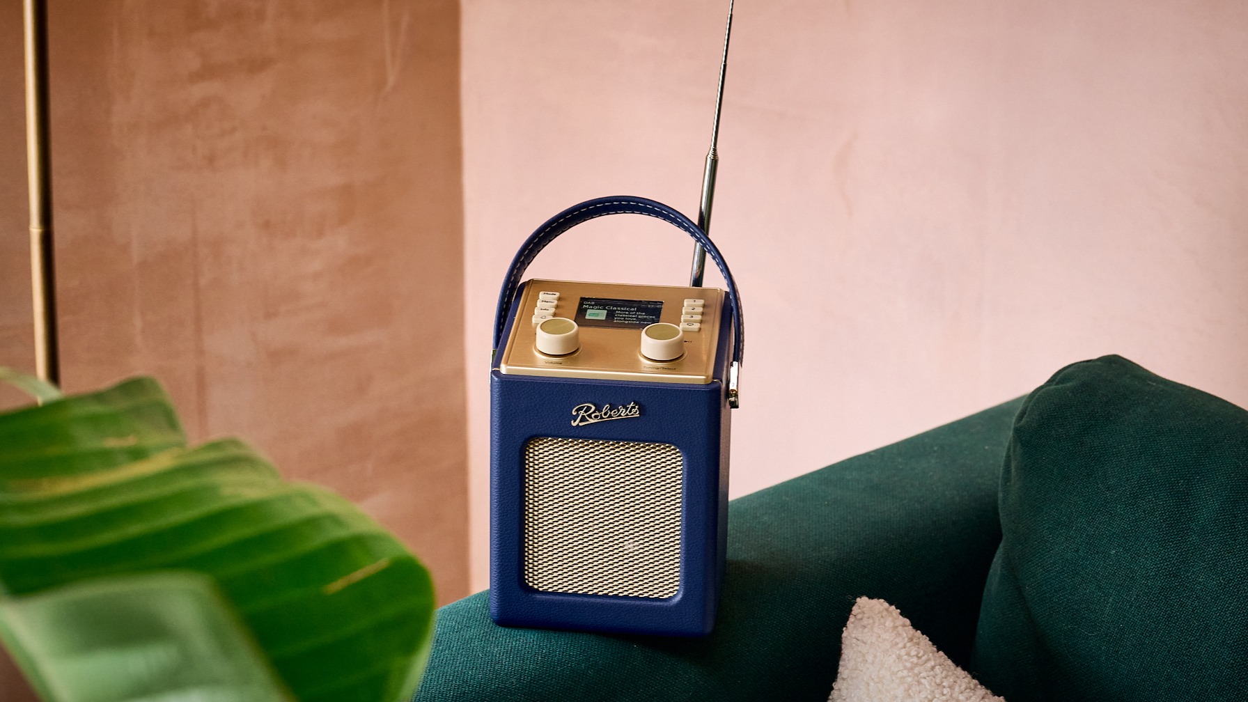 Roberts Revival Mini 2 radio in blue on a sofa